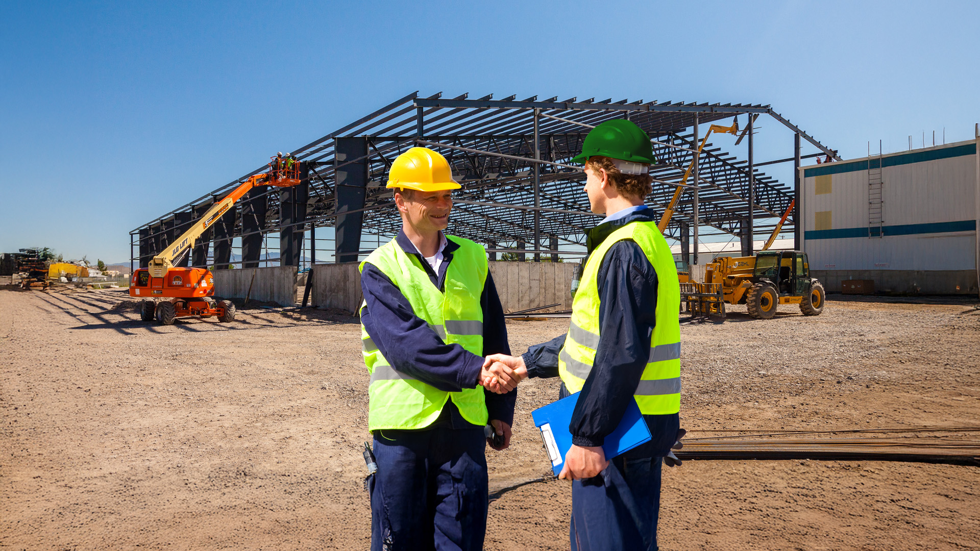 Metal building contractor and client shaking hands in front of a pre-engineered steel building in North Carolina